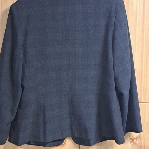 Women's black jacket with unique collar design and metallic detail