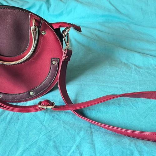 Round red shoulder bag