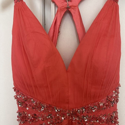 Coral short evening dress with crisscross straps, V neckline, and shiny embroidered beads
