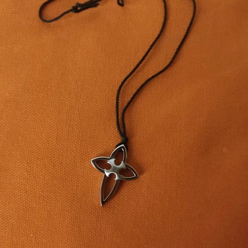 Pendant cross made of steel with cord in unique design like new