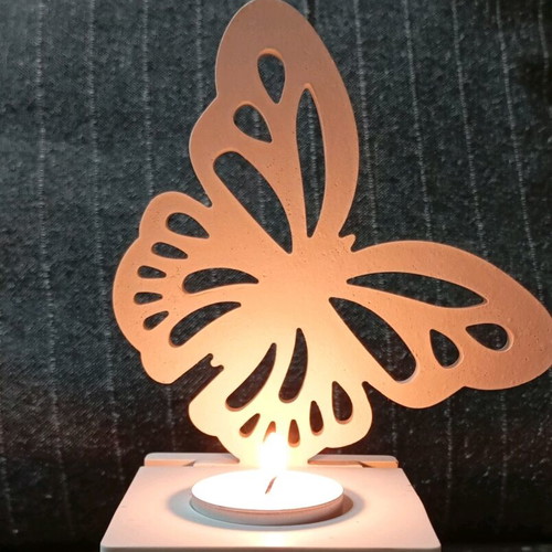 Decorative candle holder with butterfly design in white porcelain powder