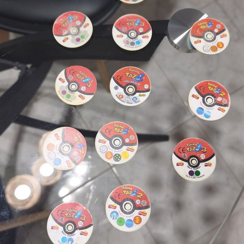 Pokemon Tazos used with visible wear