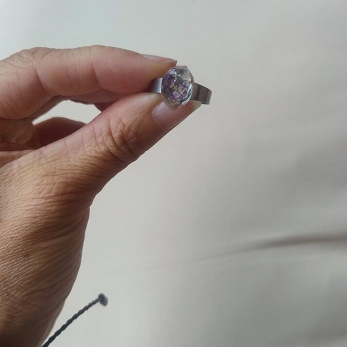 Floral ring handmade with lilac flowers in epoxy resin