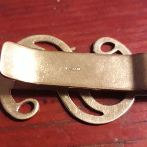 Gold-plated money clip used with $ symbol