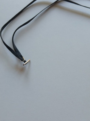 Silver cross with cord like new