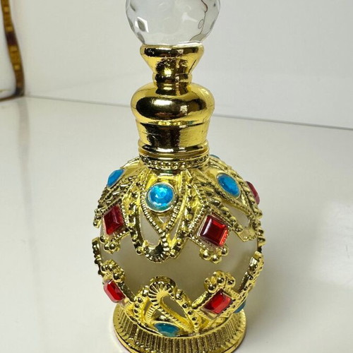 Vintage Arabic perfume bottle with gold metal frame and stones