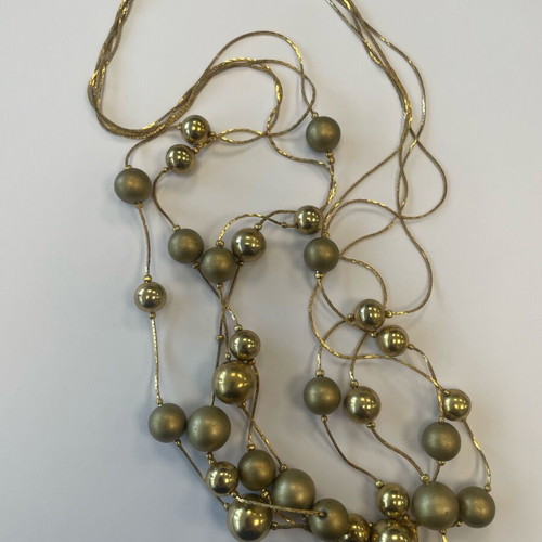 Statement necklace used with shiny and matte gold beads