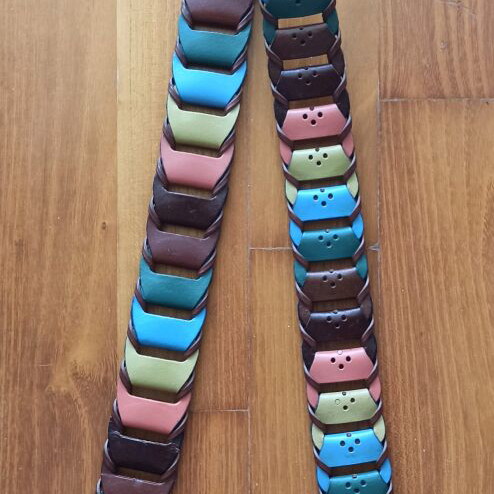 Colorful woven belt in warm shades made of faux leather, like new