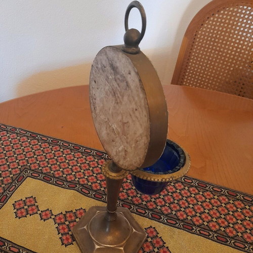 Bronze religious lamp used with embossed Virgin Mary image on stone base