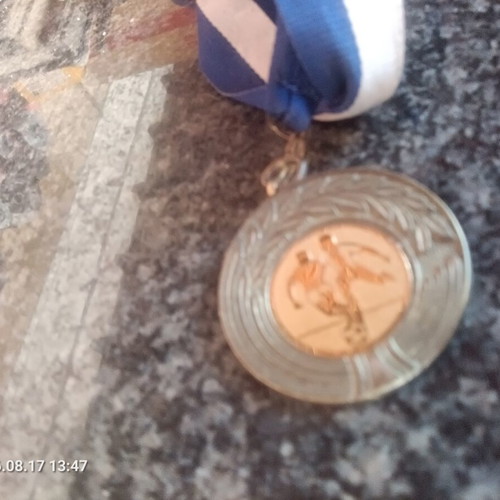 Football collectible medal with gold details