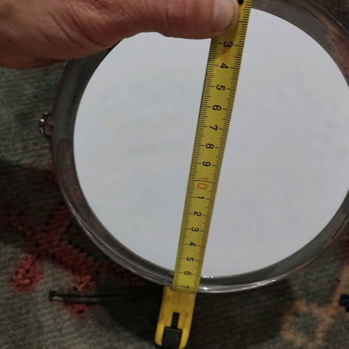 Small mirror used with magnifying side