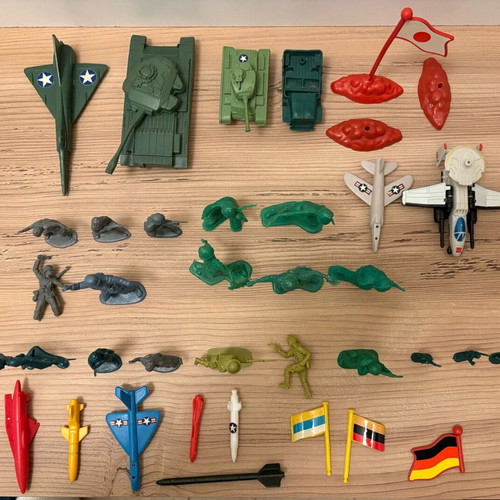 Vintage plastic military toys used with vehicles, flags and rockets