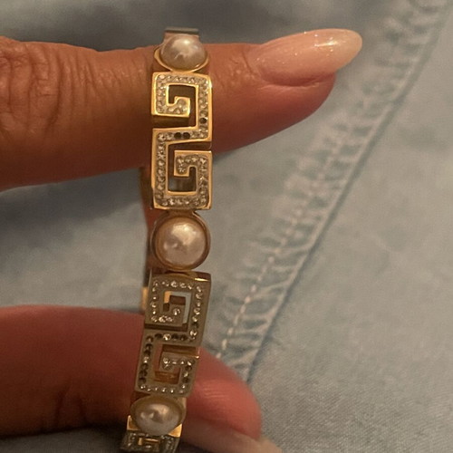 Steel bracelet used, gold color with meander design, crystals and pearls