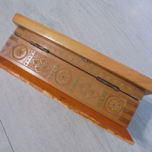 Old wooden carved box with decorative ornaments, used