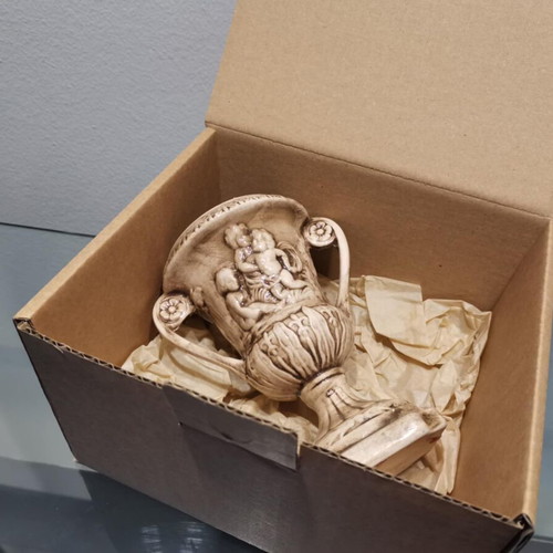 Faience amphora used with embossed design and cupids