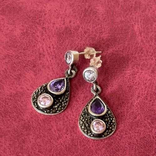 Silver earrings used with purple stones