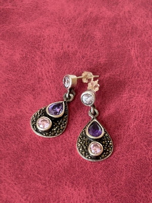 Silver earrings used with purple stones