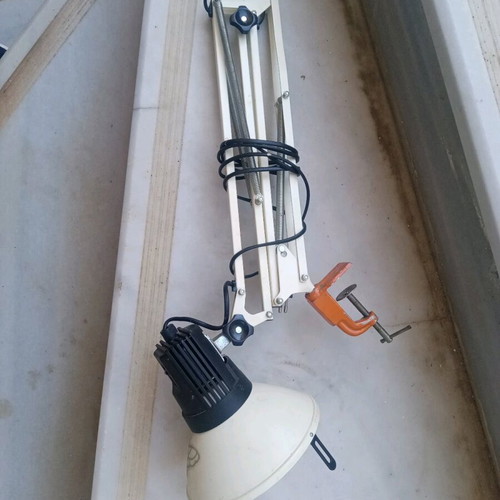 Office lamp with articulated spring and spiral clock