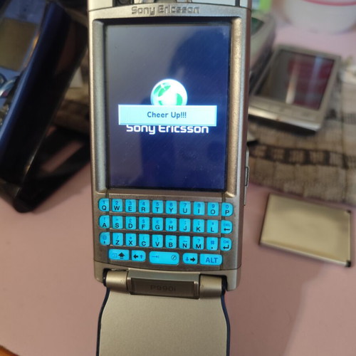 Sony Ericsson P990i vintage cell phone used with charger