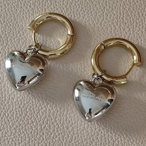 Balenciaga earrings with two tone dangling hearts like new