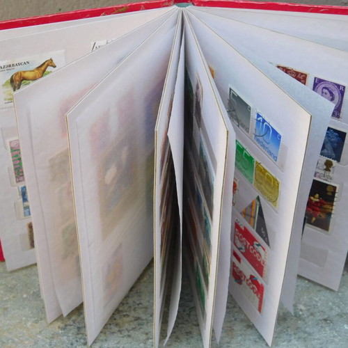 Red album with worldwide collectible stamps