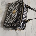 Black and white handbag with dual zipper and spacious interior