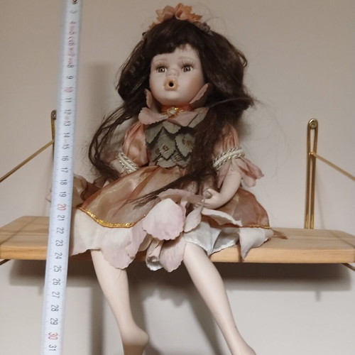 Porcelain doll sitting pose