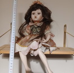 Porcelain doll sitting pose