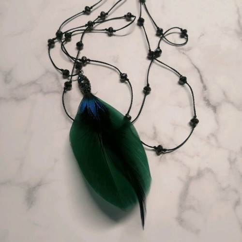 Long necklace with crystals and green feather motif like new
