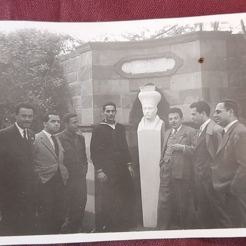 Vintage black and white photo of Namık Kemal bust with naval men