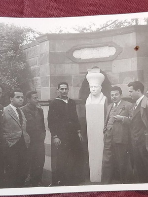 Vintage black and white photo of Namık Kemal bust with naval men