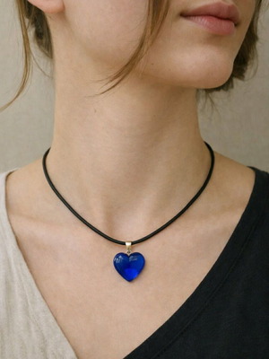 Necklace with dark blue heart on black cord like new
