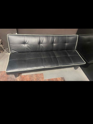 Three-seater sofa bed click-clack in black leather with white piping like new
