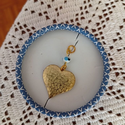 Metal heart pendant with evil eye, like new, gold color