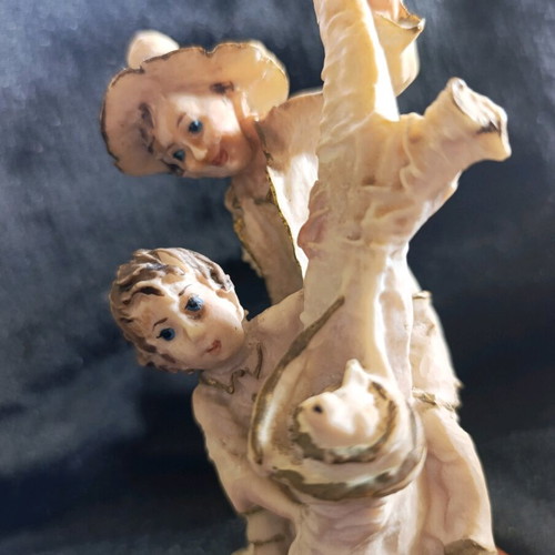 Vintage decorative figurine with children, used