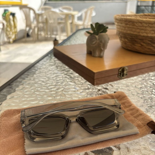 Sunglasses like new with gray semi-transparent frame, cloth and velvet case