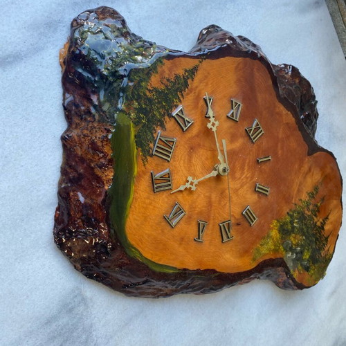 Handmade wooden wall clock from tree trunk.