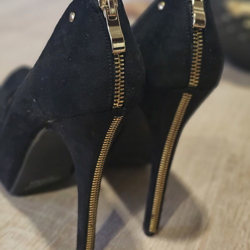 Black suede high heels with gold zipper
