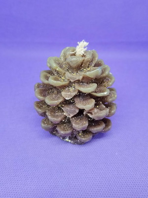 Decorative candle in pine cone shape like new