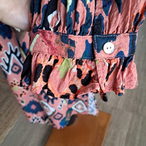 Pom dress used with geometric pattern in pink, blue and green