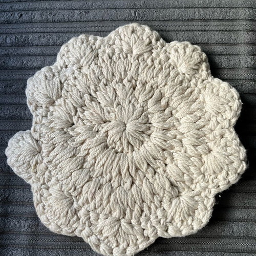 Knitted coaster used, flower-shaped, beige