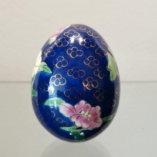 Porcelain egg used with hand-painted flowers and decorative butterflies