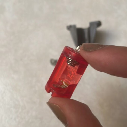 Small battery-operated LED light with cap