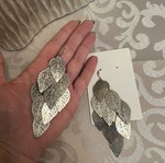 Silver dangling earrings with leaf design used