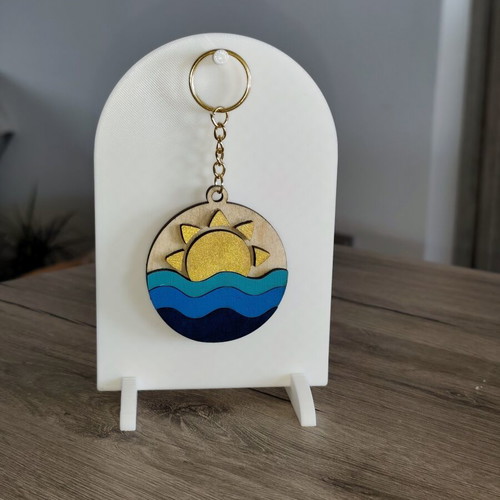 Handmade wooden summer keychain with laser cut sun and waves design