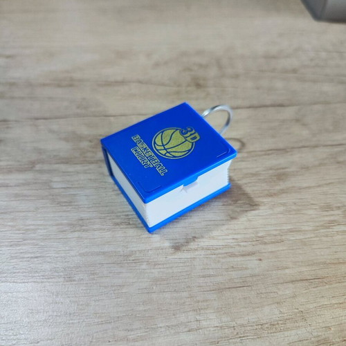 3D book keychain like new that turns into a basketball court blue