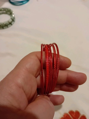 Set of thin metal bracelets in red color like new