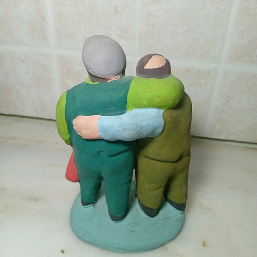 Ceramic figure of two men with traditional costumes like new