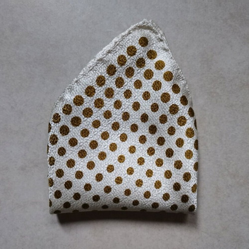 Pocket square used, white with gold dots