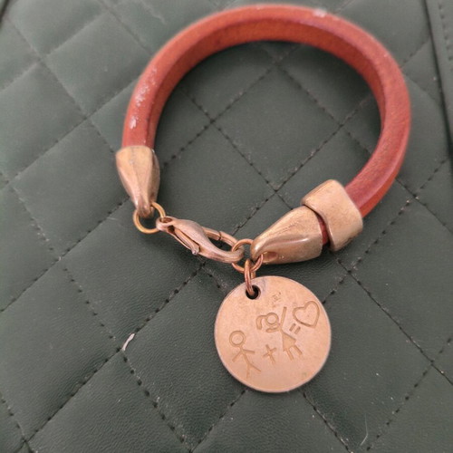 Wooden bracelet like new with gold details and round charm